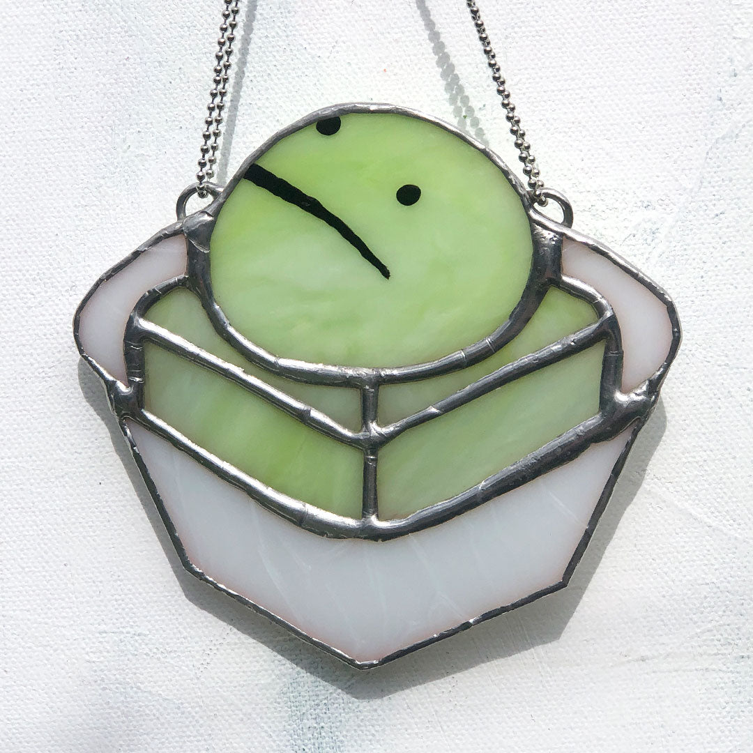 close up of green frog cake stained glass suncatcher