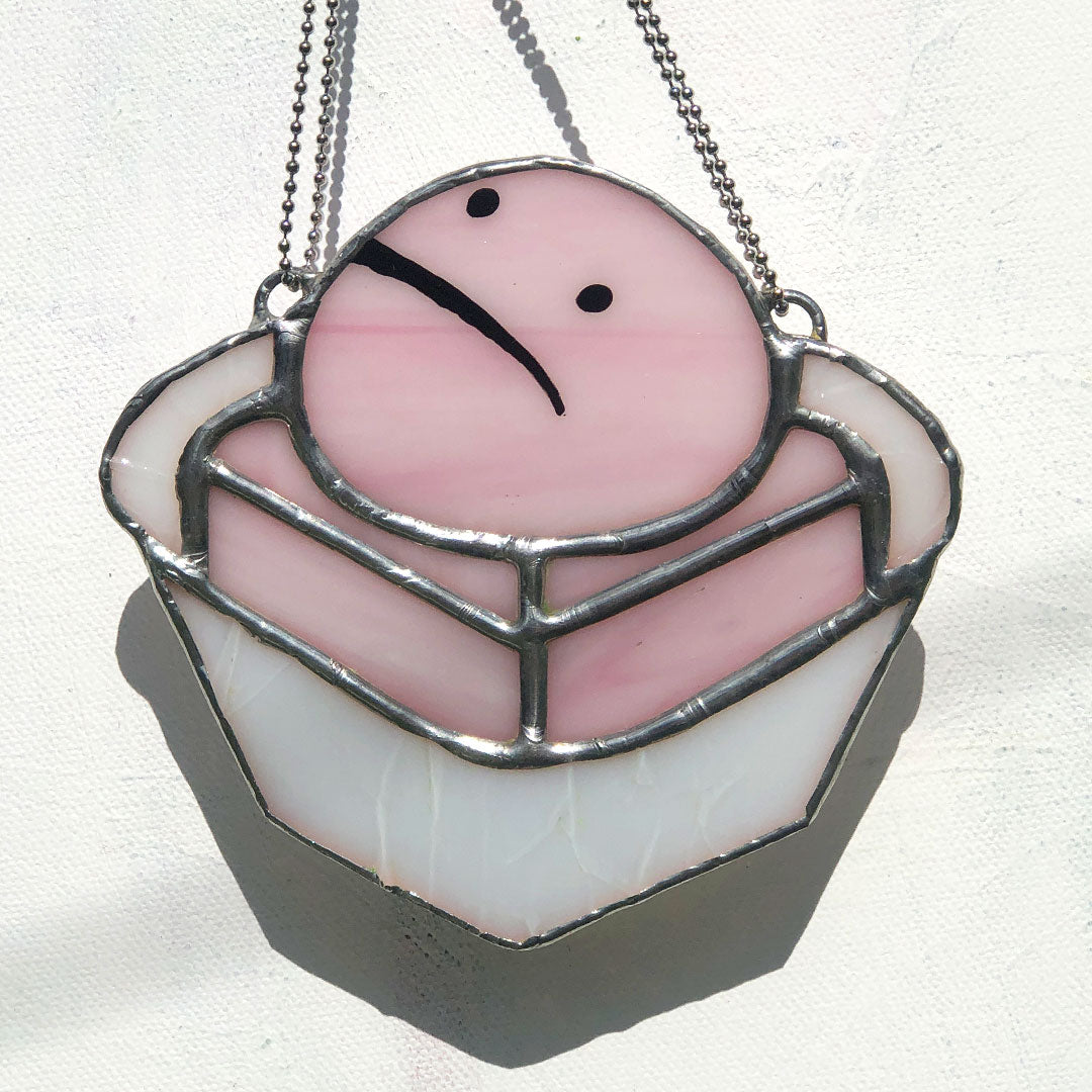 close up of pink frog cake stained glass suncatcher