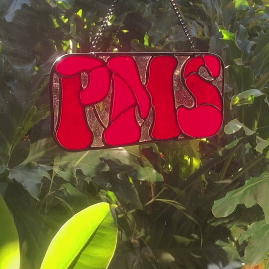 short video of red PMS stained glass sign twirling and catching the light
