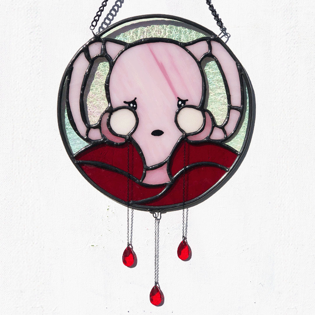 don't ovary act uterus stained glass shown against sunlit white background