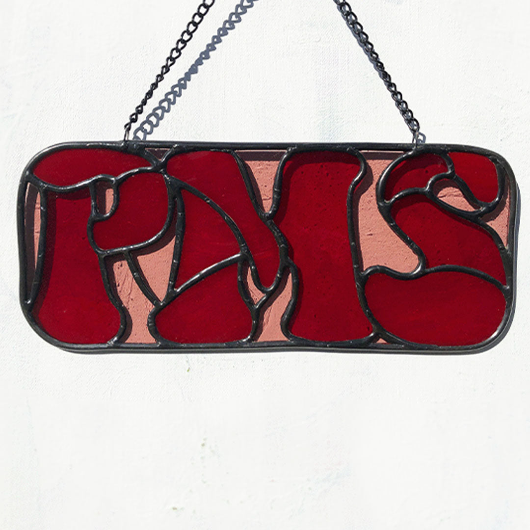 red PMS stained glass sign against white background