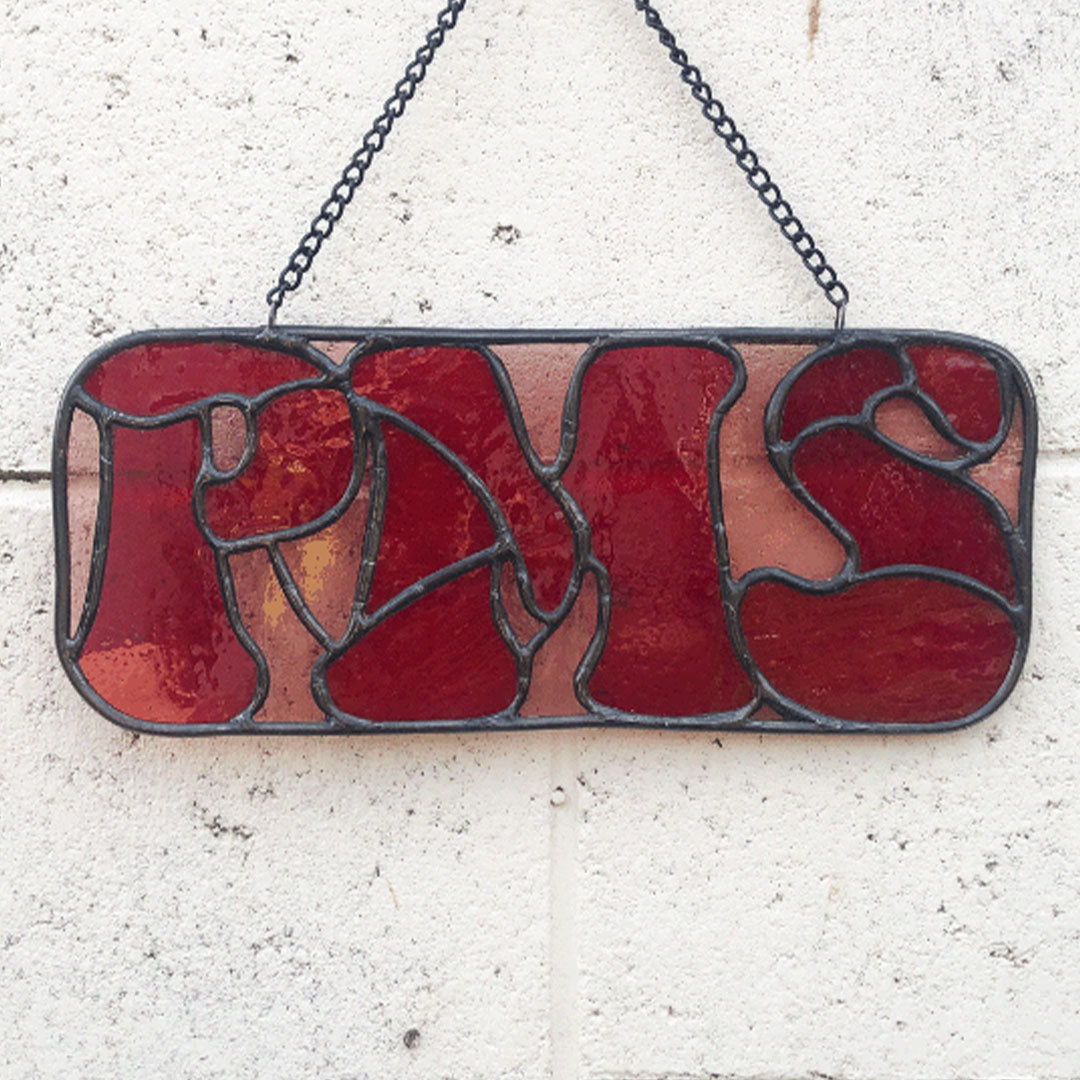 red PMS stained glass sign against white background without sun streaming through