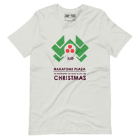 Silver coloured t-shirt with parodied Nakatomi Plaza logo from Die Hard to resemble green holly leaves and red berries with the text Its beginning to look a lot like Christmas
