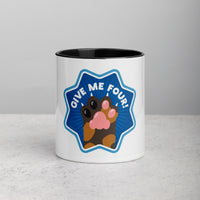 front facing image of a white mug with black interior and handle. Mug has image of a tortoiseshell cats paw on a blue 8 sided star with the text 'give me four' 