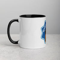 left hand facing image of a white mug with black interior and handle. Mug has image of a tortoiseshell cats paw on a blue 8 sided star with the text 'give me four' 
