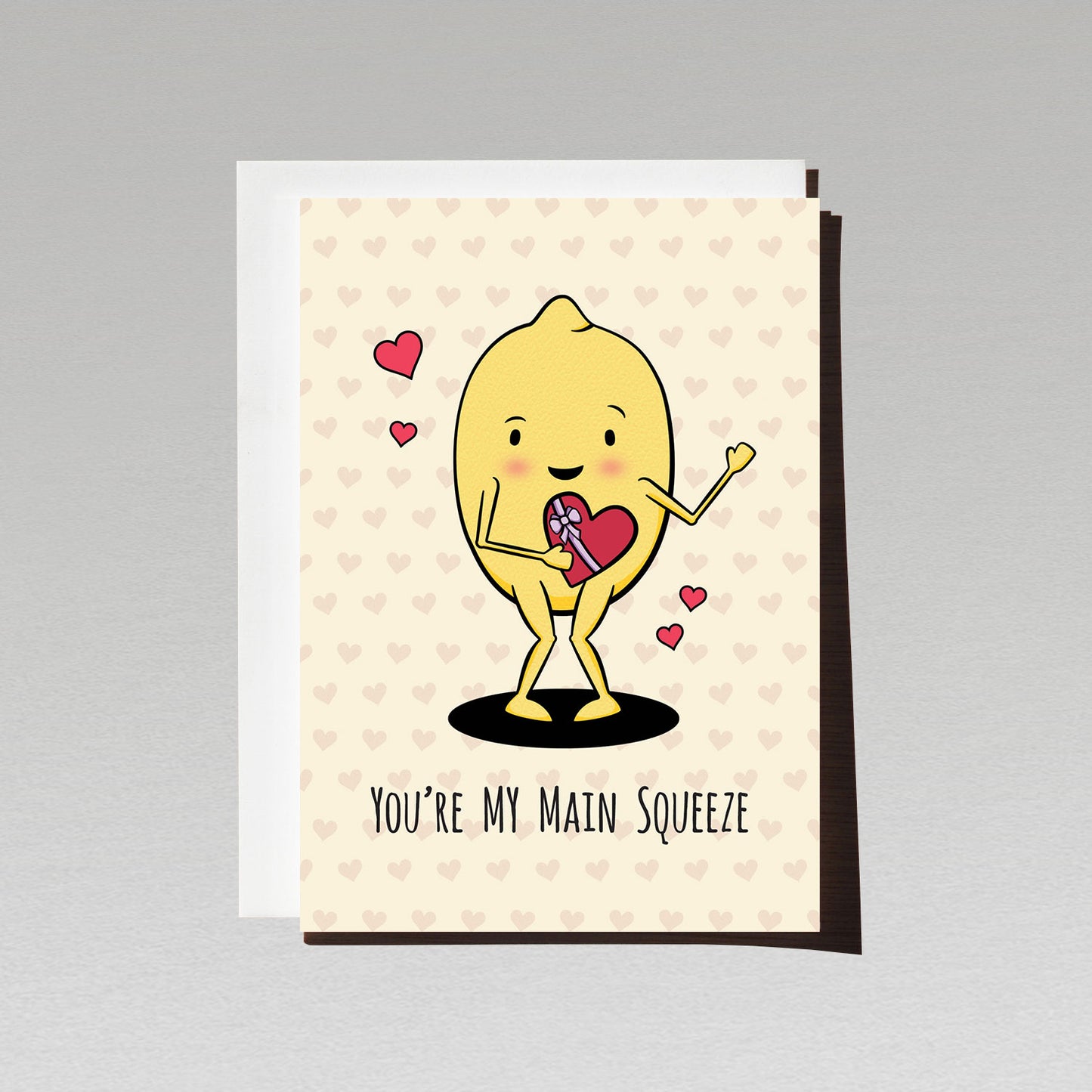 Greeting card with cute lemon character holding heart shaped box of chocolates with text youre my main squeeze