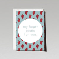 Greeting card with red anatomical hearts on blue background with text My heart beats for you
