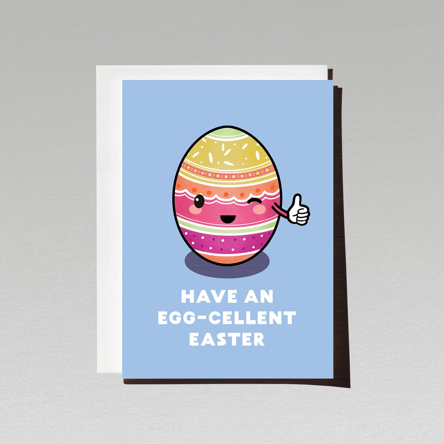 greeting card with happy cute pink and yellow easter egg on blue bacground smiling and giving thumbs up with text have an eggcellent easter