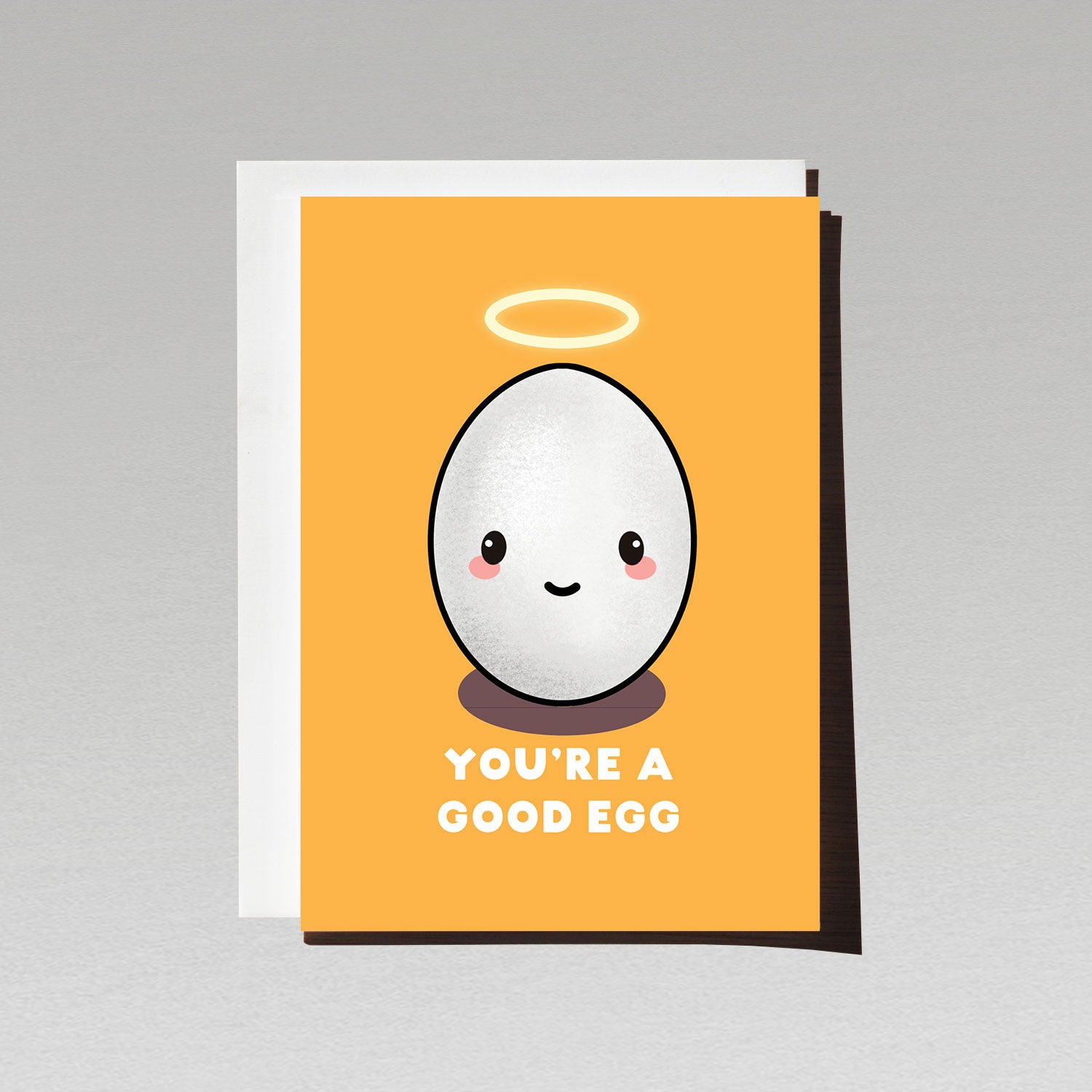 Greeting card with cute smiling white egg character with angel halo on orange background with text You're a good egg