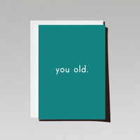 Birthday card with minimalist white text you old. on dark green background