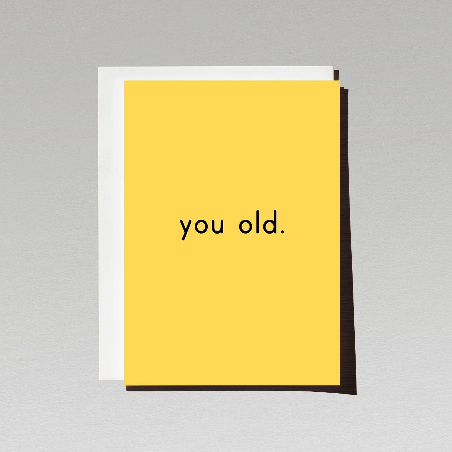 Birthday card with minimalist white text you old. on yellow background
